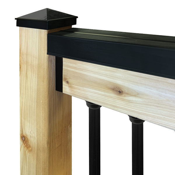 A Rail Shield™ deck post with a black cap and railing features a light wood finish on the post and horizontal panel. Black vertical balusters contrast against the durable polycarbonate structure, all set against a plain white background. Product: Rail Shield - Handrail Covers.