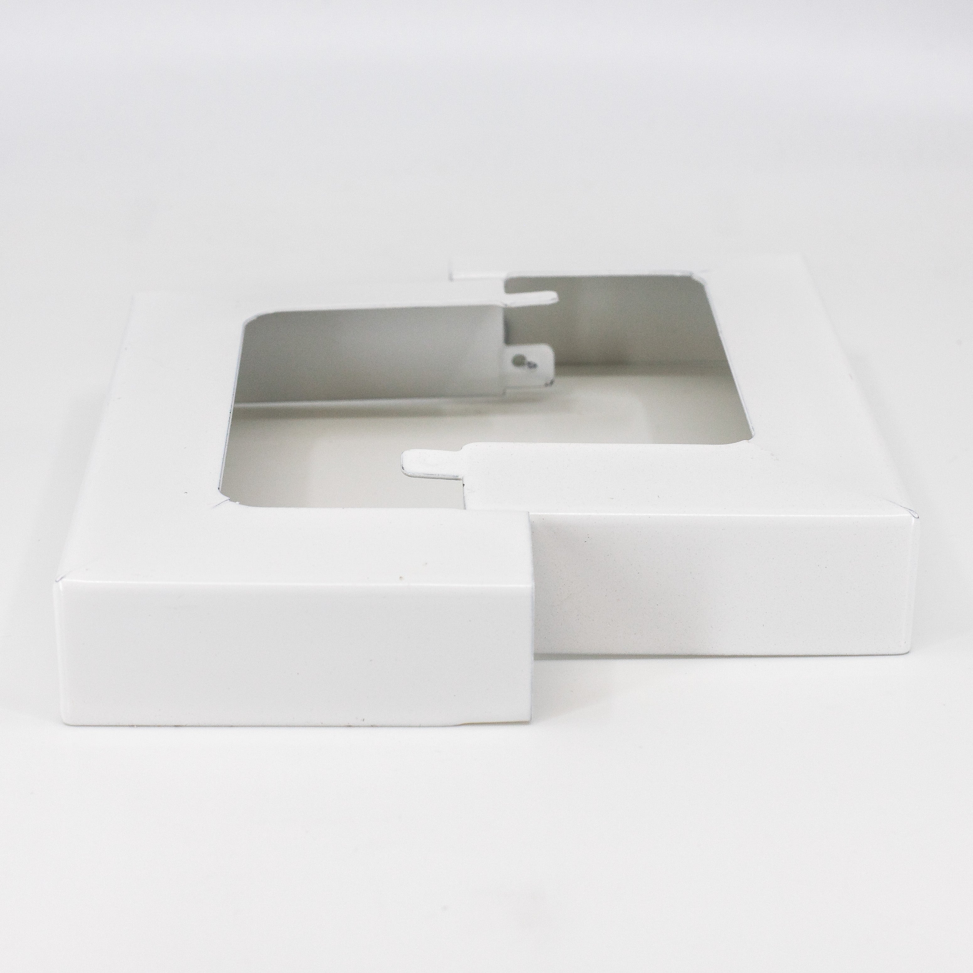 A white flat rectangular box with a clear window displays the 4x4 Double Bundle - White/Black zinc-coated metal post skirts. The open box on a plain white background highlights the sleek, durable design of these essential outdoor fixtures.