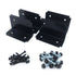 In the background, four black metal brackets stand like sentries. Up front, two hardware piles: black screws on the left and silver bolts with nuts on the right, all displayed on a white surface. This setup suggests a strong construction suitable for Deck Foot - Floating - Ground Contact use.