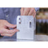 Someone is carefully assembling a metal corner bracket engraved with TITAN. They use 1/4x3 Galv. Hex Head Lag Screws to attach it, ready to secure deck foot anchors seamlessly. The bracket, featuring two vertical slots, stands upright on a table.