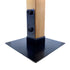 A wooden post is mounted on a square black metal base, resembling pergola stability. Secured by two large T.C Bolts™ 4x4 (pair) on a flat metal bracket, the base appears sturdy and designed for reliable support.