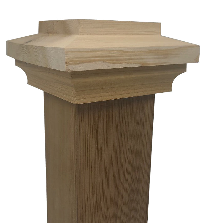 A close-up of a wooden pillar featuring a square decorative cap. Its smooth finish highlights the natural grain of knotty cedar, and the elegant beveled top is reminiscent of Island Knotty Cedar Post Caps, adding an architectural touch.