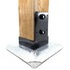 The close-up shows a wooden beam snugly secured in a black metal bracket, fastened to a shiny square metal base with two T.C Bolts™ 6x6 (pair), enhancing stability for robust structural support, ideal for pergola posts.