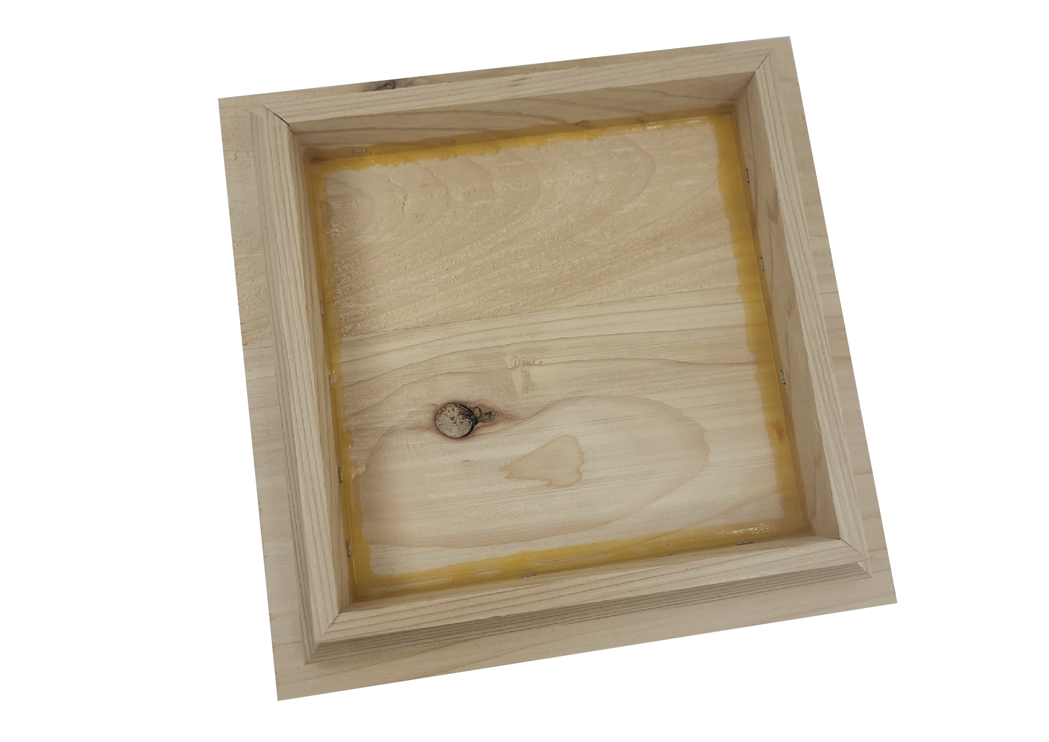 The Island Knotty Cedar Post Cap features a wooden frame made of knotty cedar, boasting an open back that highlights the natural wood and visible knots. It appears unfinished with a recessed central area, set against a plain black background.