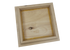 The Island Knotty Cedar Post Cap features a wooden frame made of knotty cedar, boasting an open back that highlights the natural wood and visible knots. It appears unfinished with a recessed central area, set against a plain black background.