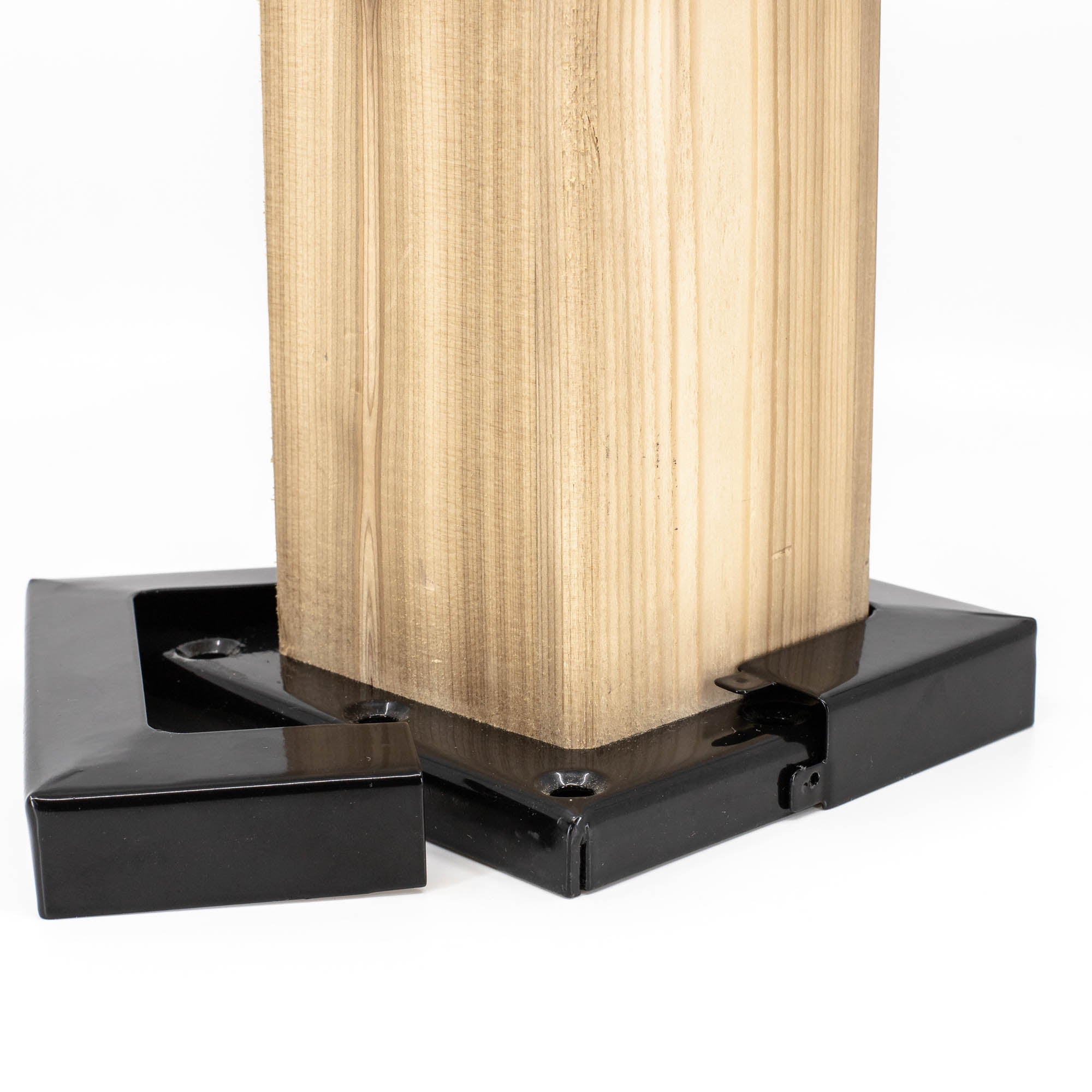 The Metal Post Skirts secure at the base with black metal supports, ensuring stability and durability. The sleek design contrasts beautifully with natural wood grain, while durable galvanized elements enhance overall strength.