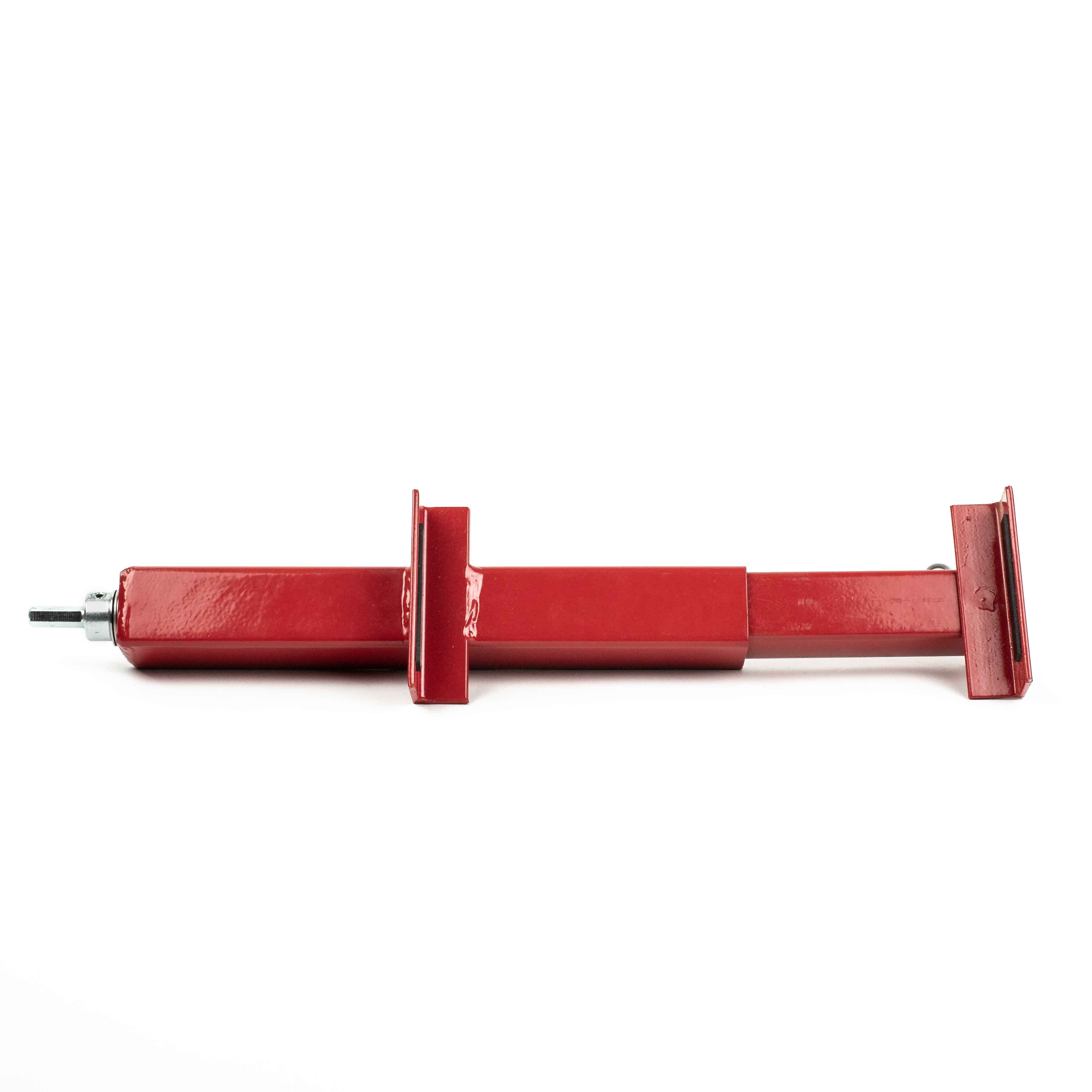 The Deck Devil Board Straightener by Titan is a red, rectangular metal support brace with adjustable extensions for structural support. This telescopic device provides precise push or pull power and is displayed horizontally against a plain white background.