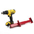 A yellow and black DeWalt power drill with a battery pack sits next to a red Deck Devil Board Straightener by Titan. Ideal for precise support, the straightener is designed for reinforcement or locking tasks, adding extra strength to your projects.