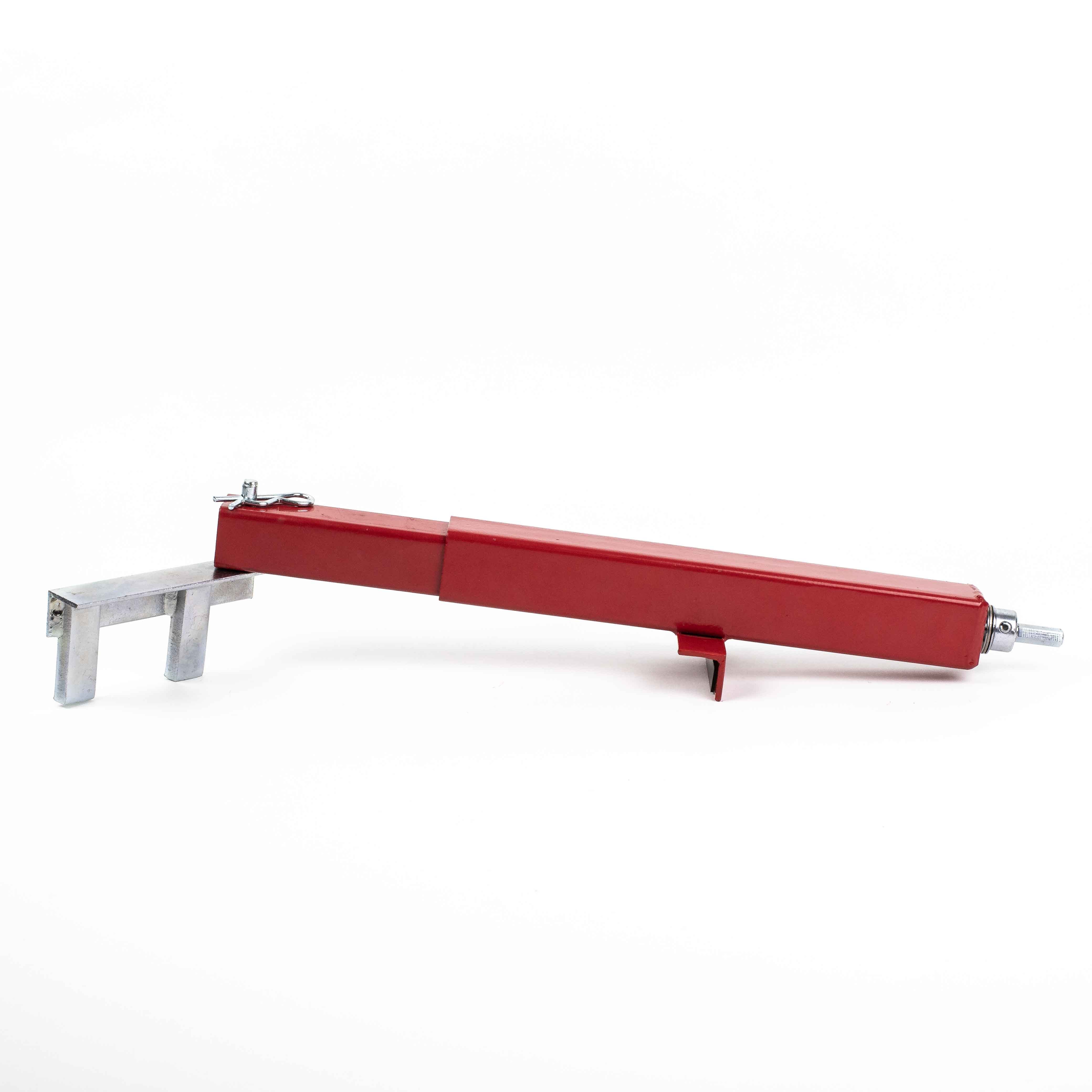 The Deck Devil Board Straightener by Titan is a red metal mechanical part with a rectangular extension on one end and an attachment point on the other, suggesting industrial use for providing precise push or pull power. It is shown on a plain white background.