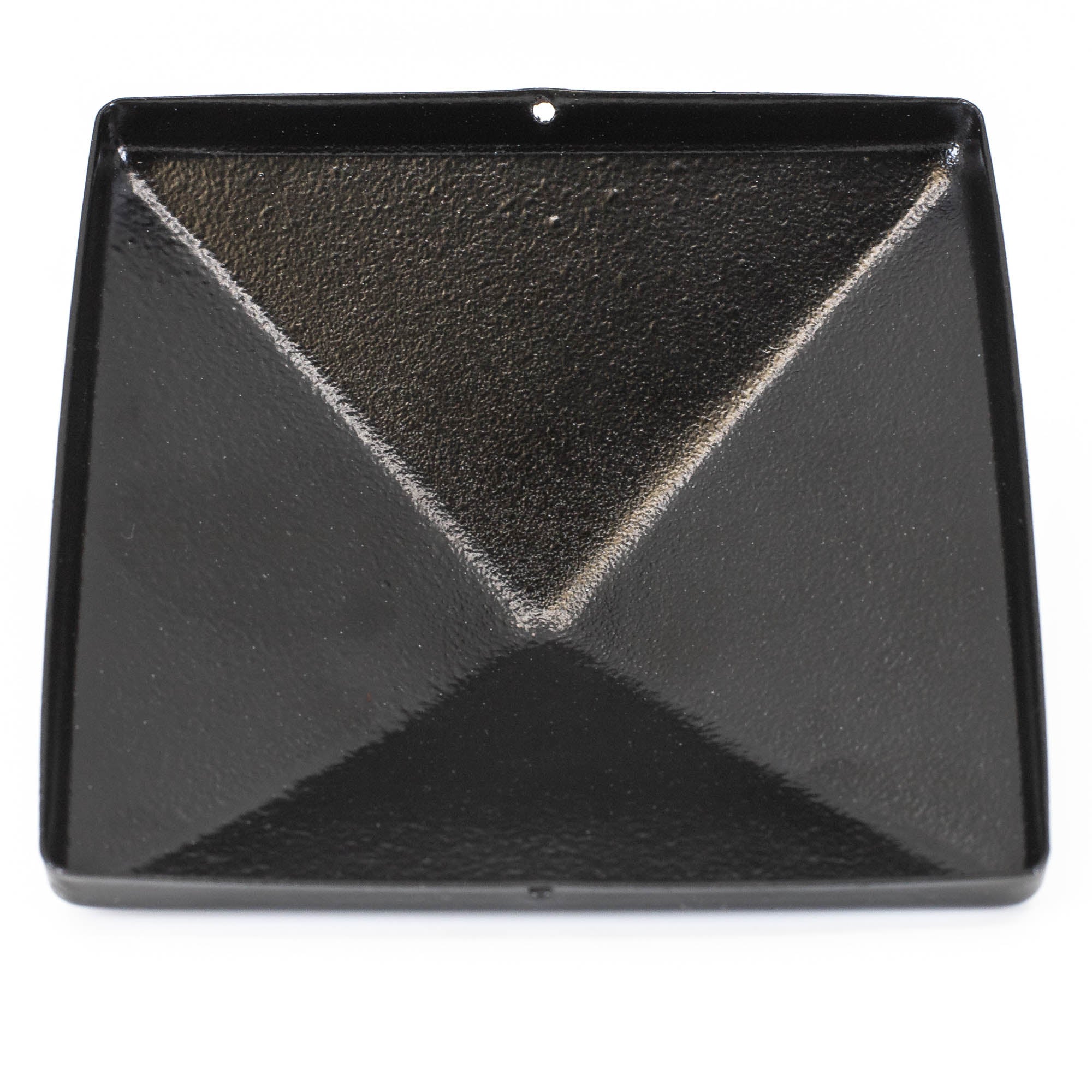 A square black metal amplifier pan with raised edges and a central diamond-shaped indent, created to reflect sound, has a small top hole resembling the mounting point found on a Pyramid Metal Post Cap.