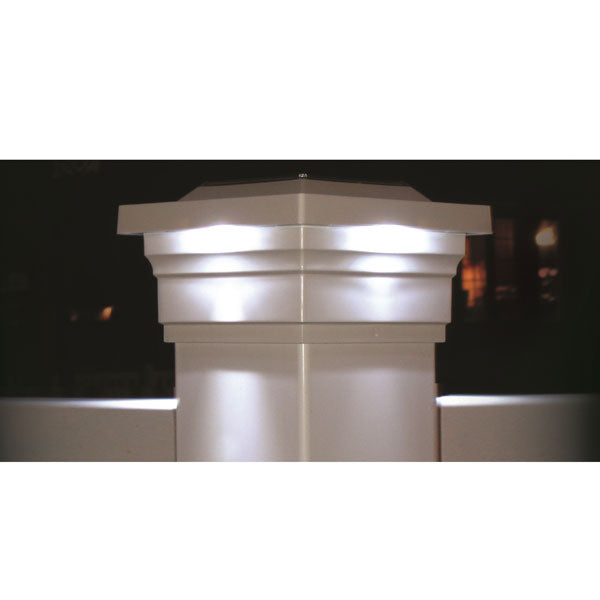 The Classy Post Cap Majestic Solar, featuring built-in LED lights and powered by rechargeable batteries, emits a gentle glow at night against a dark background.