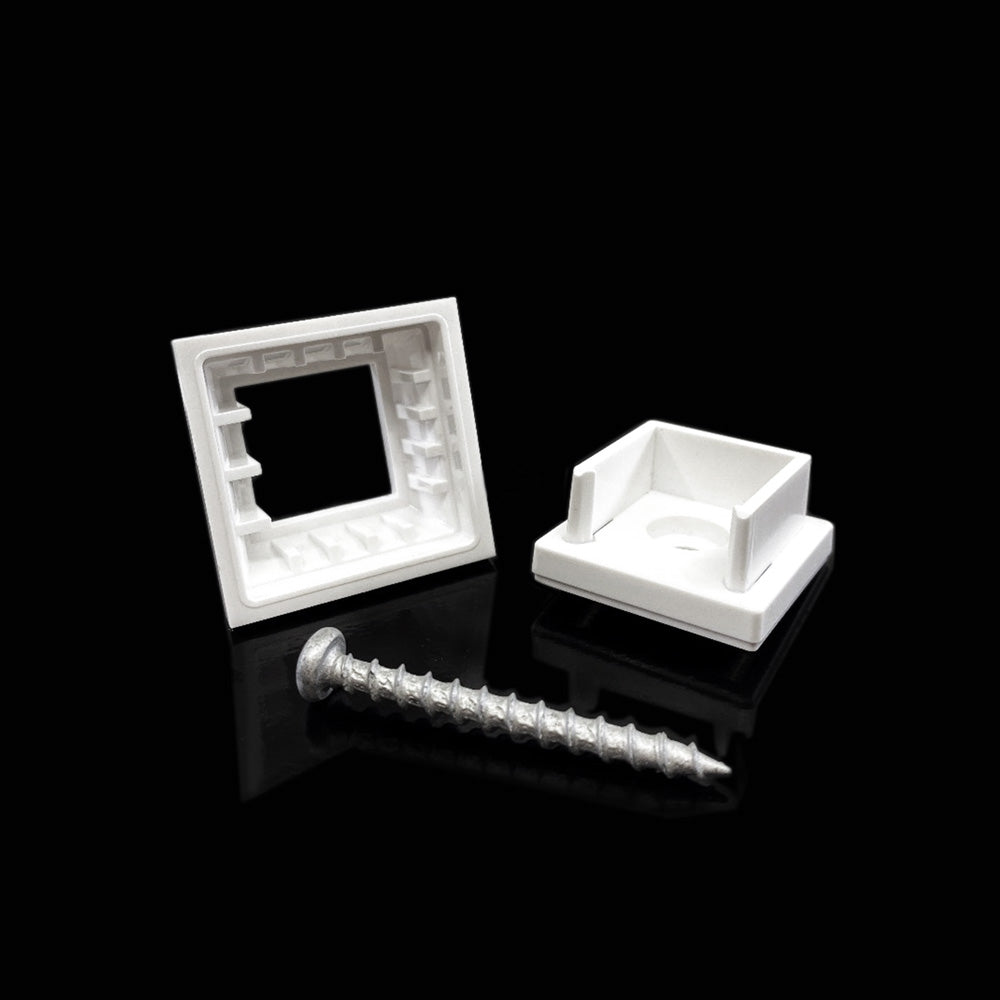 On a reflective black surface, a silver screw and two white wall anchors stand out. Resembling the Snapn Lock® Baluster Connectors Square 20 Pack, one anchor, with its square, open design, lays down while the other stands upright with a recessed center.