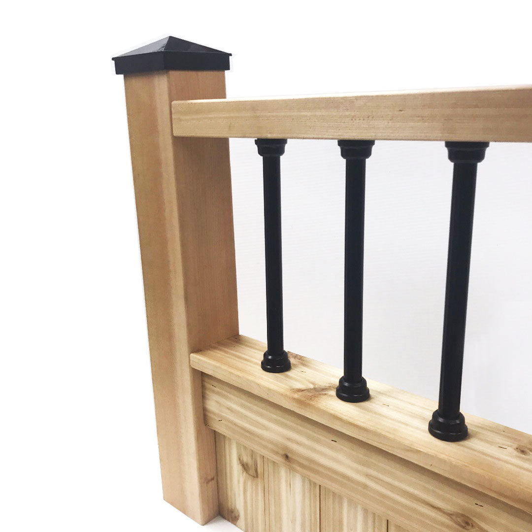 Wooden railing with square posts and black aluminum balusters, capped with a sleek Snapn Lock® Fence Topper™ - Round. The wood has a natural finish with evenly spaced balusters against a plain white background.