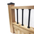 Wooden railing with square posts and black aluminum balusters, capped with a sleek Snapn Lock® Fence Topper™ - Round. The wood has a natural finish with evenly spaced balusters against a plain white background.