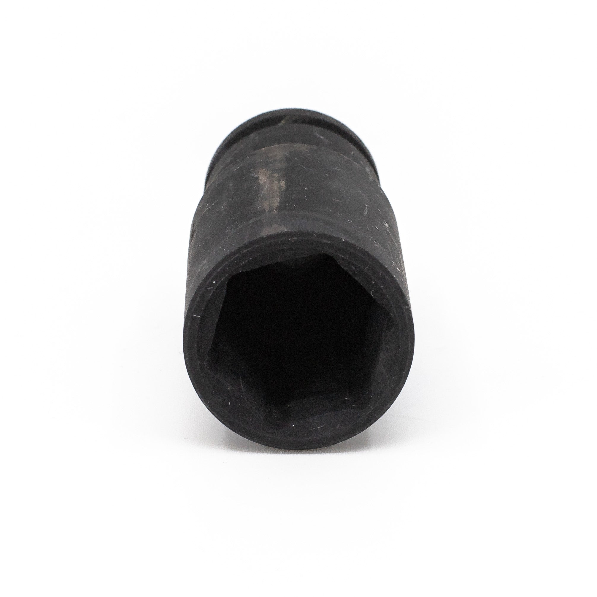 Close-up of a black, cylindrical Impact Socket with a hexagonal opening, crafted from durable chrome vanadium. The slightly worn surface suggests previous use. Ideal for those seeking reliable tools like the Deep Impact Sockets series or an Impact Socket Bundle.