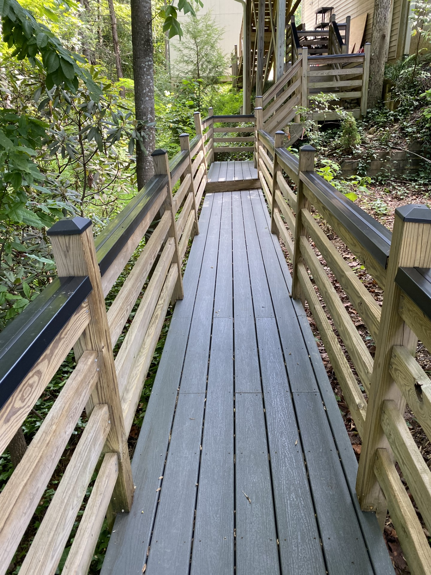 Beautiful wooden railing with rail shield hadnrail covers on the top 