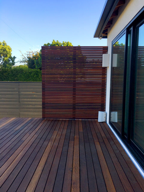 privacy wall with brown stained wood in a backyard