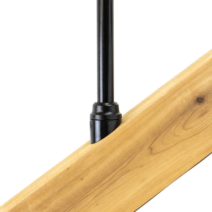 Close-up of a Snapn Lock® Stair Adapter Plus Connector Pack in black, attached at an angle to a light-colored wooden plank. The wood grain is visible, suggesting integration into a railing system or furniture piece.