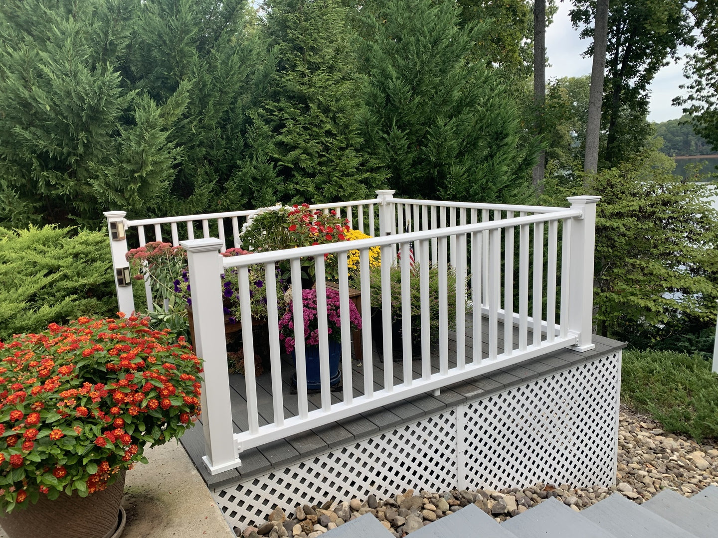 railing section filled with potted flowers and shrubbery 