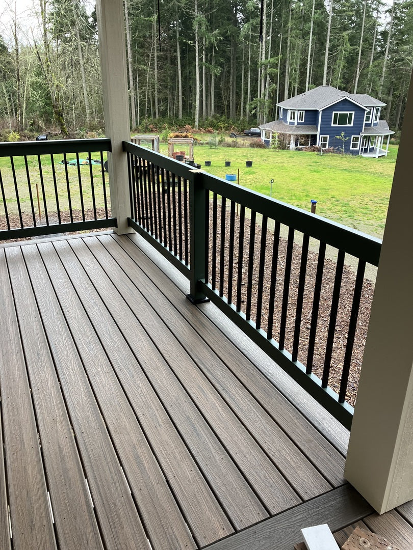 beautiful wood rail with posts supported by titan wood post anchors, overlooking a large backyard