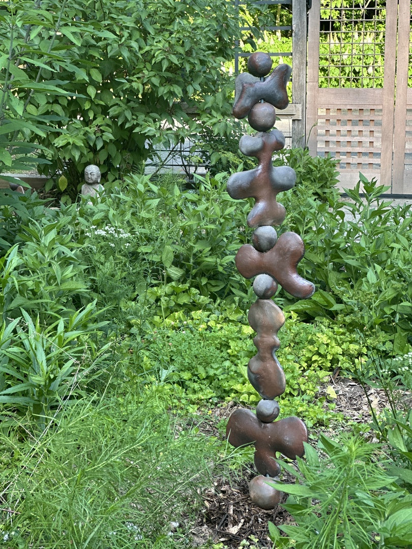 abstract art anchored in the ground using a helical auger