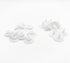 White plastic snap fasteners and grommet-like hardware pieces arranged on a plain white background.